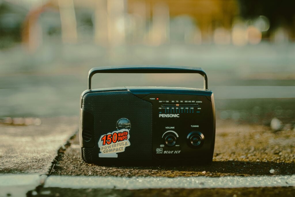 A retro portable radio on an urban surface, evoking a vintage and nostalgic vibe.